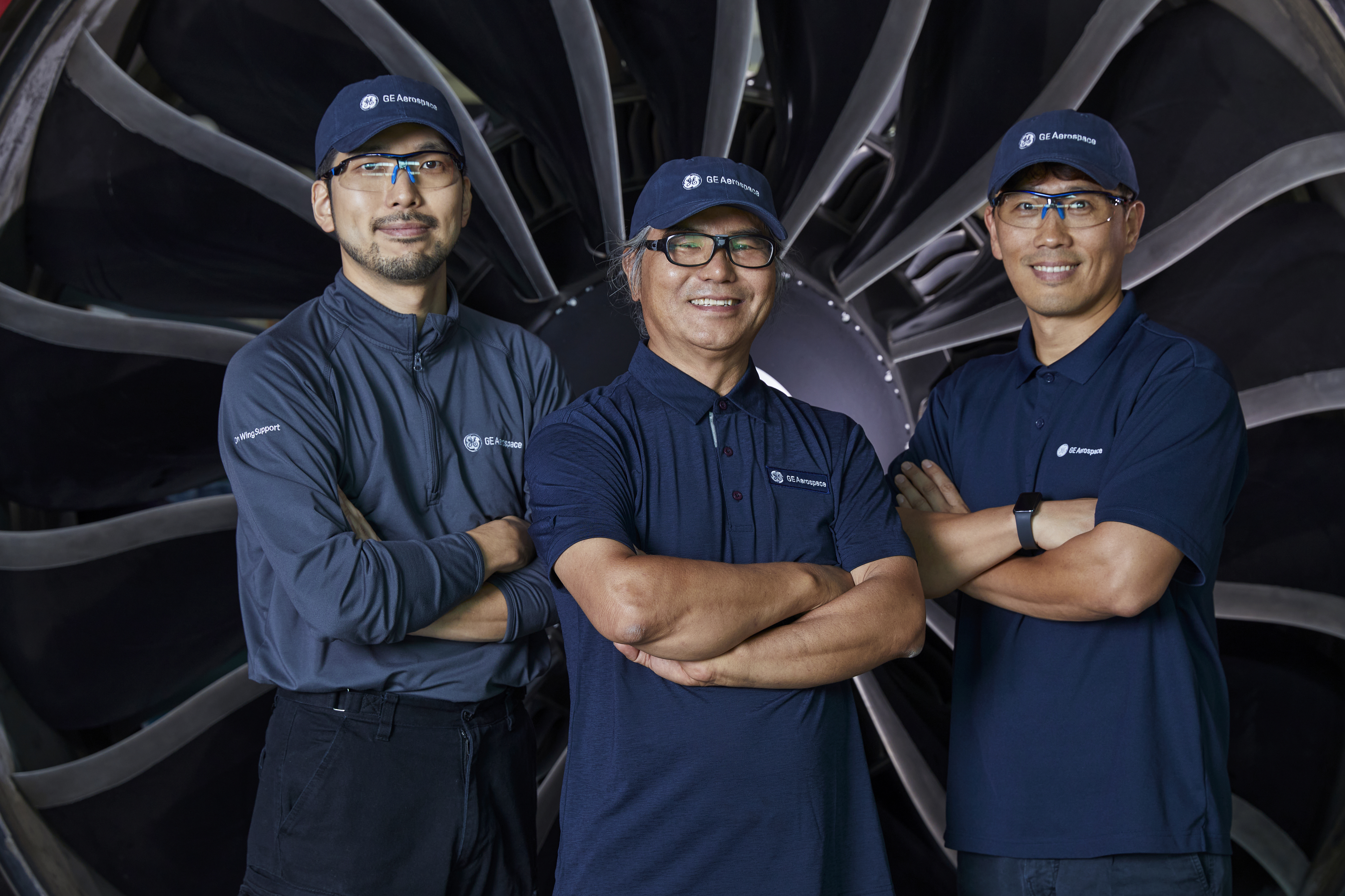 3 people in front of a fan engine