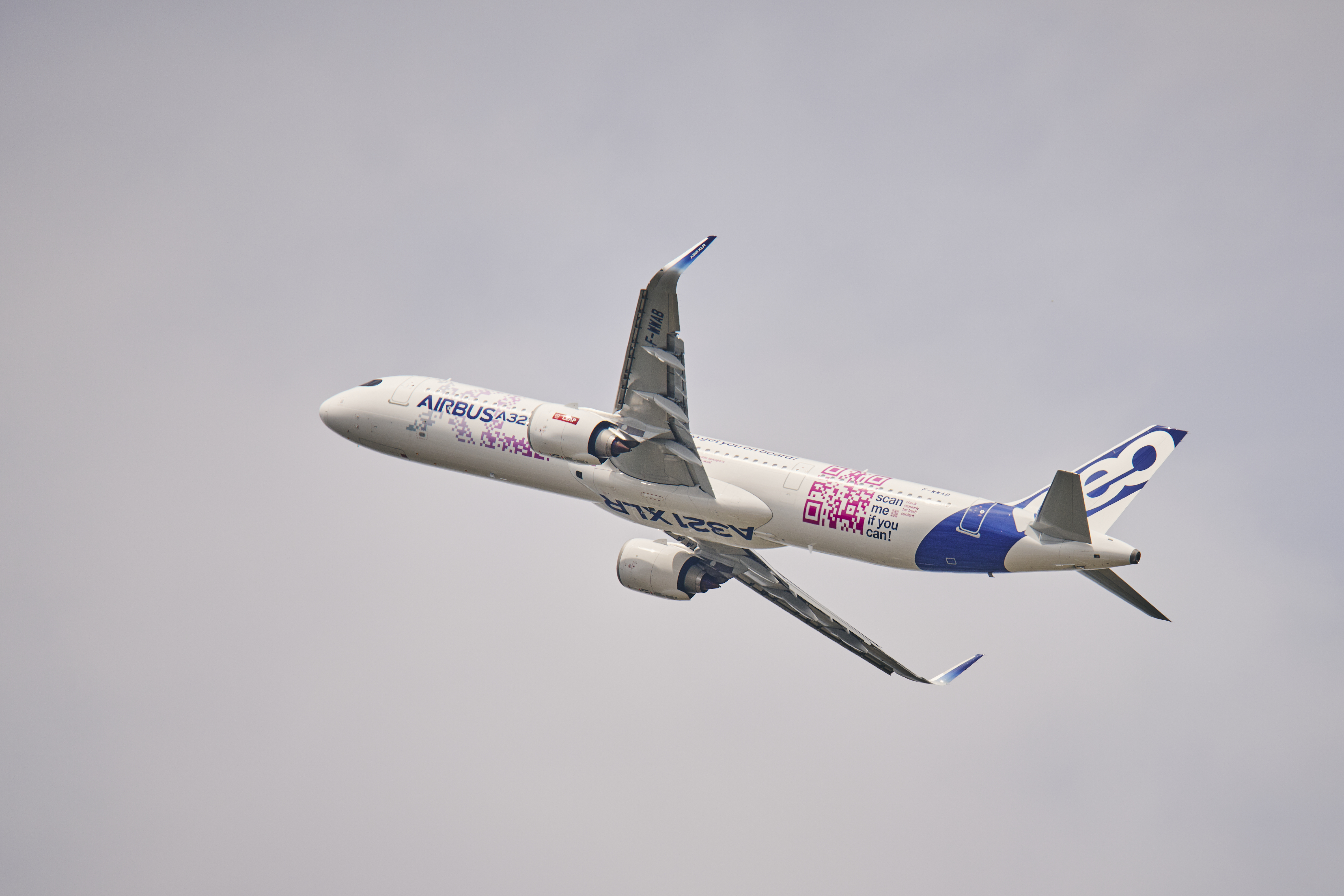 Airbus A321XLR flying through cloudy skies