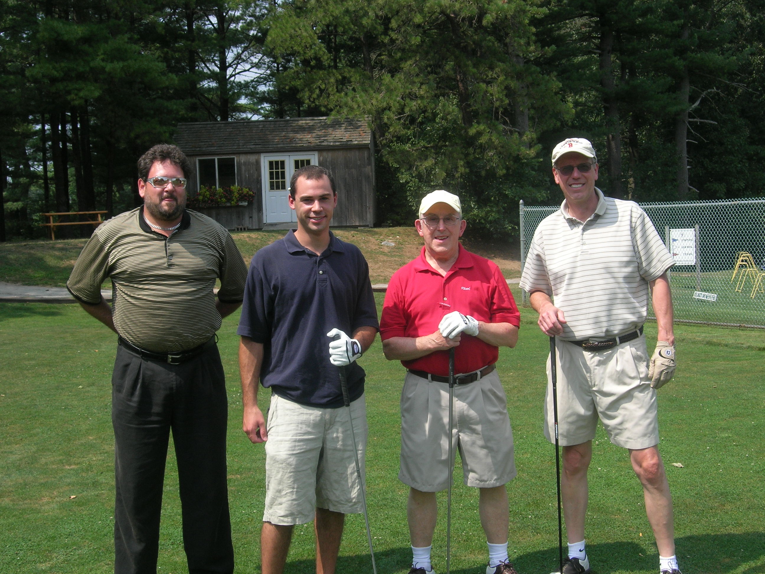 4 men on golf green