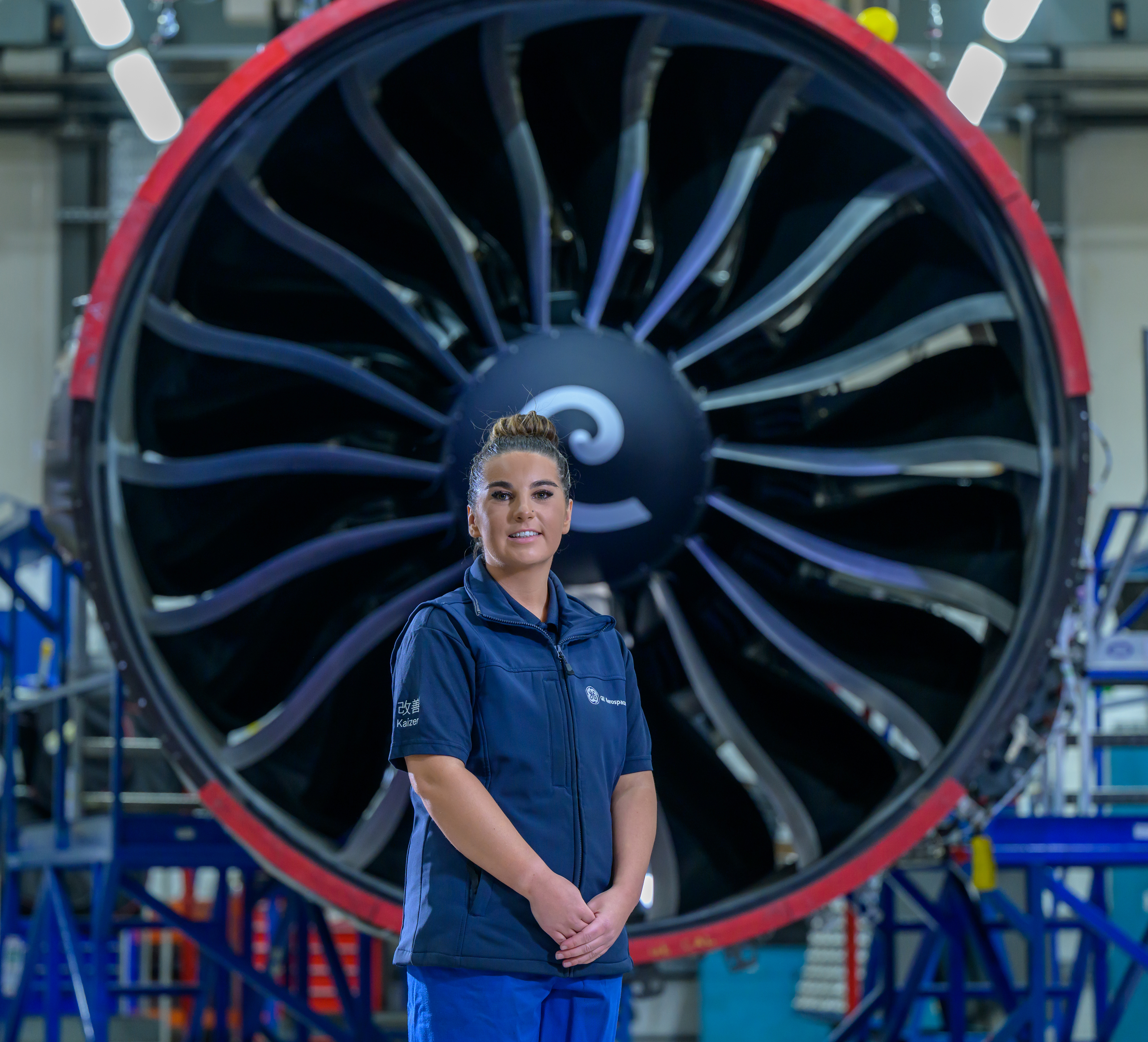 Woman standing in front of a large engine