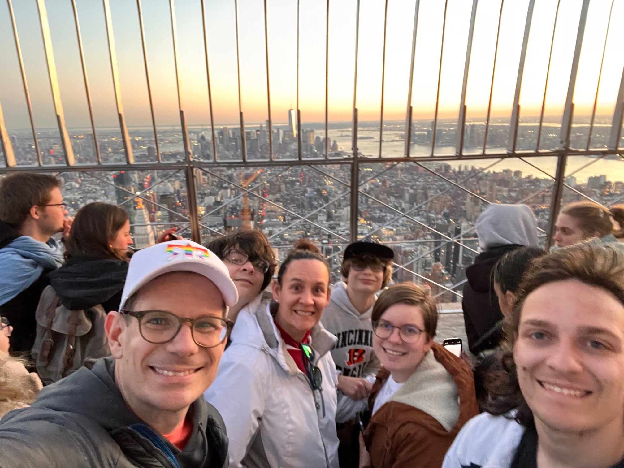 Pfeiffer and his family taking a selfie on a balcony overlooking a city at sunset